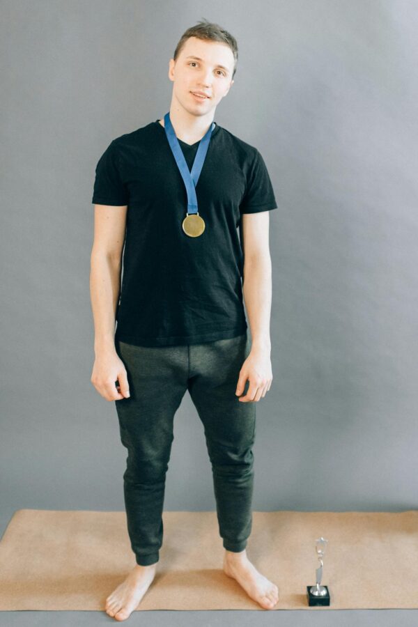 Man in Black Shirt Wearing a Gold Medal