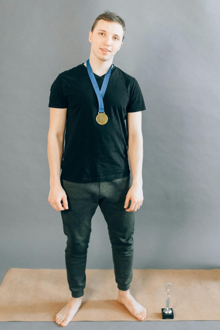 Man in Black Shirt Wearing a Gold Medal 